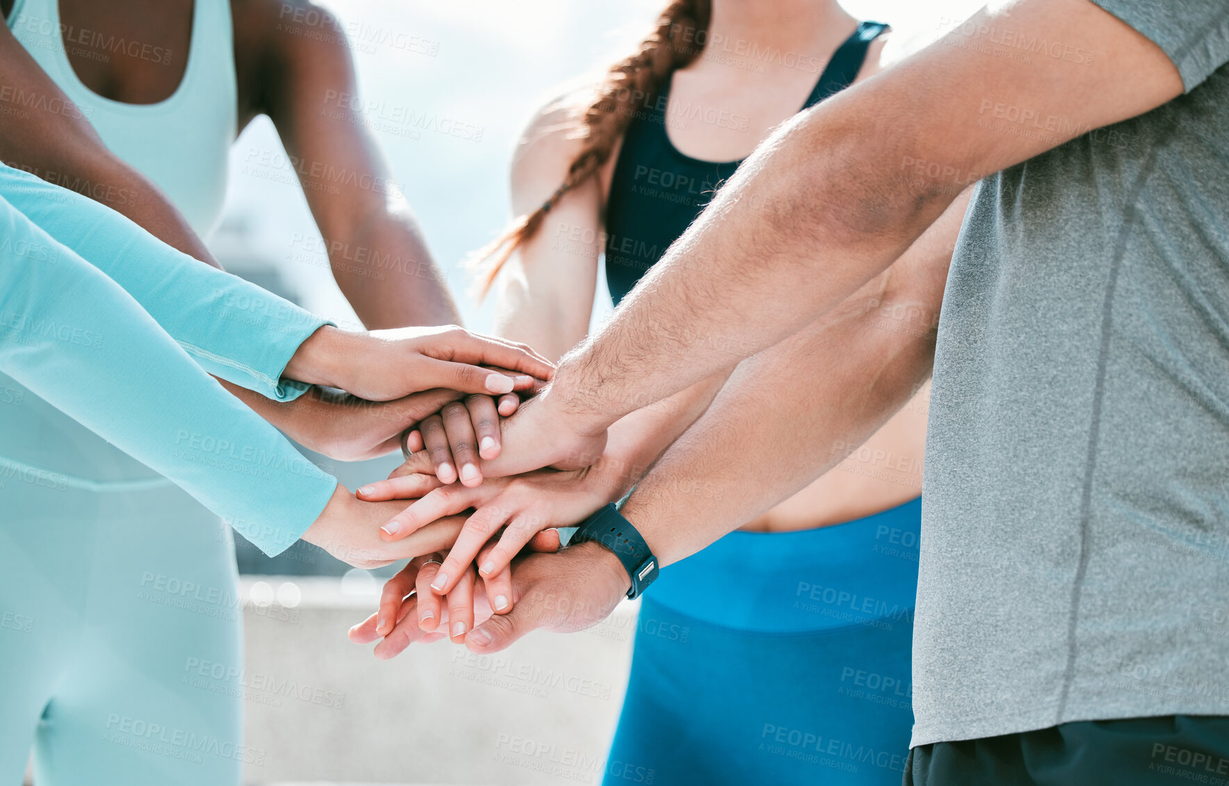 Buy stock photo Closeup of diverse group of sporty people stacking hands together in pile to express unity, support and trust. Motivated athletes huddled in circle to celebrate winning achievement. Joining for collaboration and team spirit during training workout