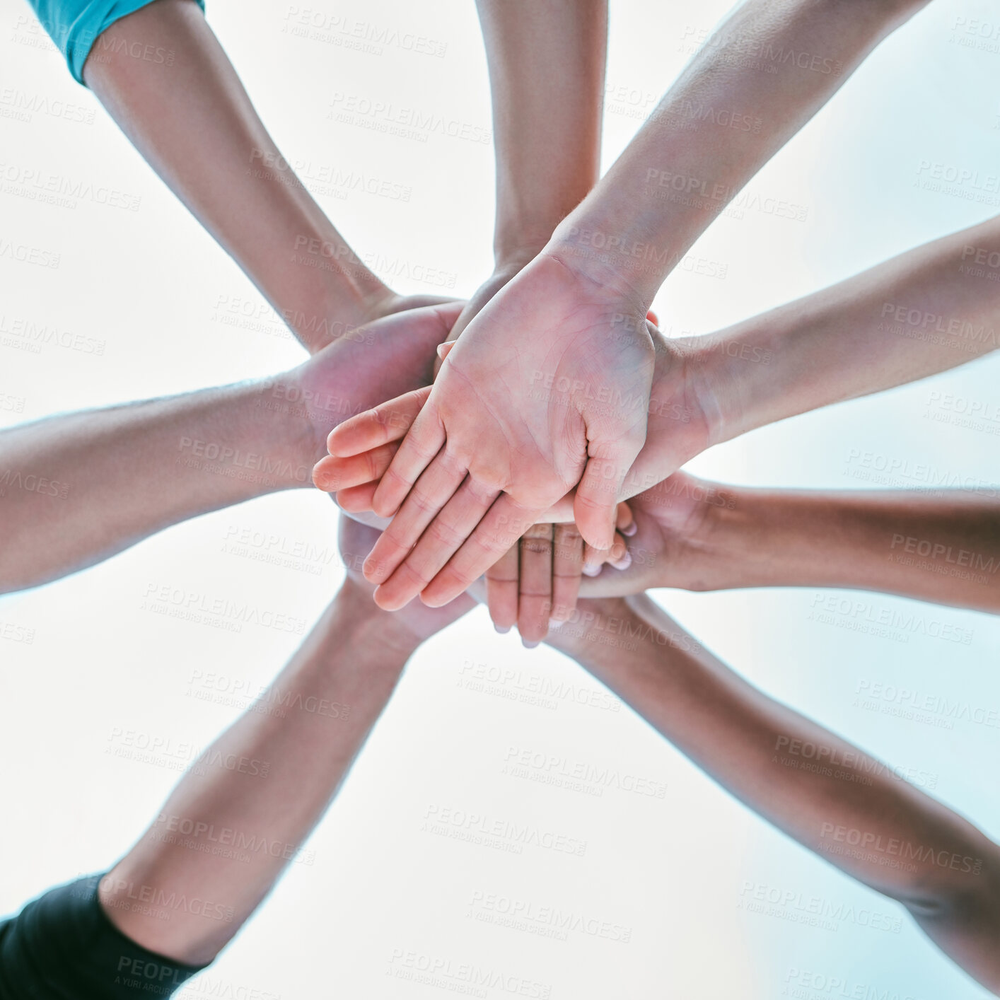 Buy stock photo Closeup of diverse group of people from below stacking hands together in a pile to express unity, support and trust. Multiracial community huddled in a circle to celebrate winning achievement. Joining for collaboration and team spirit