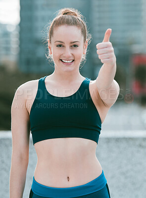 Buy stock photo Portrait of one confident young caucasian woman gesturing thumbs up while exercising outdoors. Happy female athlete looking motivated and ready for a good training workout in the city. Endorsing a healthy active lifestyle
