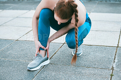 Buy stock photo Closeup of one caucasian woman holding her sore ankle while exercising outdoors. Female athlete suffering with painful foot injury from fractured joint and inflamed muscles during workout. Struggling with stiff body cramps causing discomfort and strain