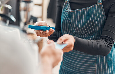 Buy stock photo Closeup of a clerk accepting a credit card payment from a customer in a cafe or store. Hands of woman using card machine reader while taking money for a purchase transaction from a man in a shop