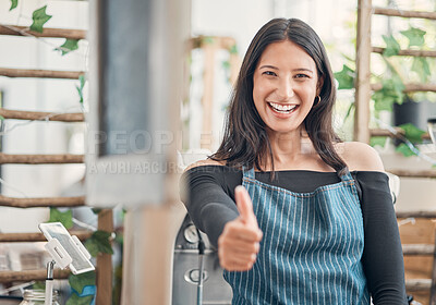 Buy stock photo Portrait of one happy young hispanic waitress showing thumbs up while working in a store or cafe. Friendly woman and coffeeshop owner managing a successful restaurant startup