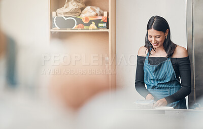 Buy stock photo One happy young hispanic waitress working in a store or cafe. Friendly woman and coffeeshop owner managing a successful restaurant startup