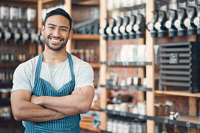 Buy stock photo Portrait of one happy young hispanic waiter standing with his arms crossed in a store or cafe. Friendly man and coffeeshop owner managing a successful restaurant startup