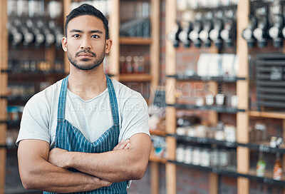 Buy stock photo Portrait of one happy young hispanic waiter standing with his arms crossed in a store or cafe. Focused man and coffeeshop owner managing a successful restaurant startup