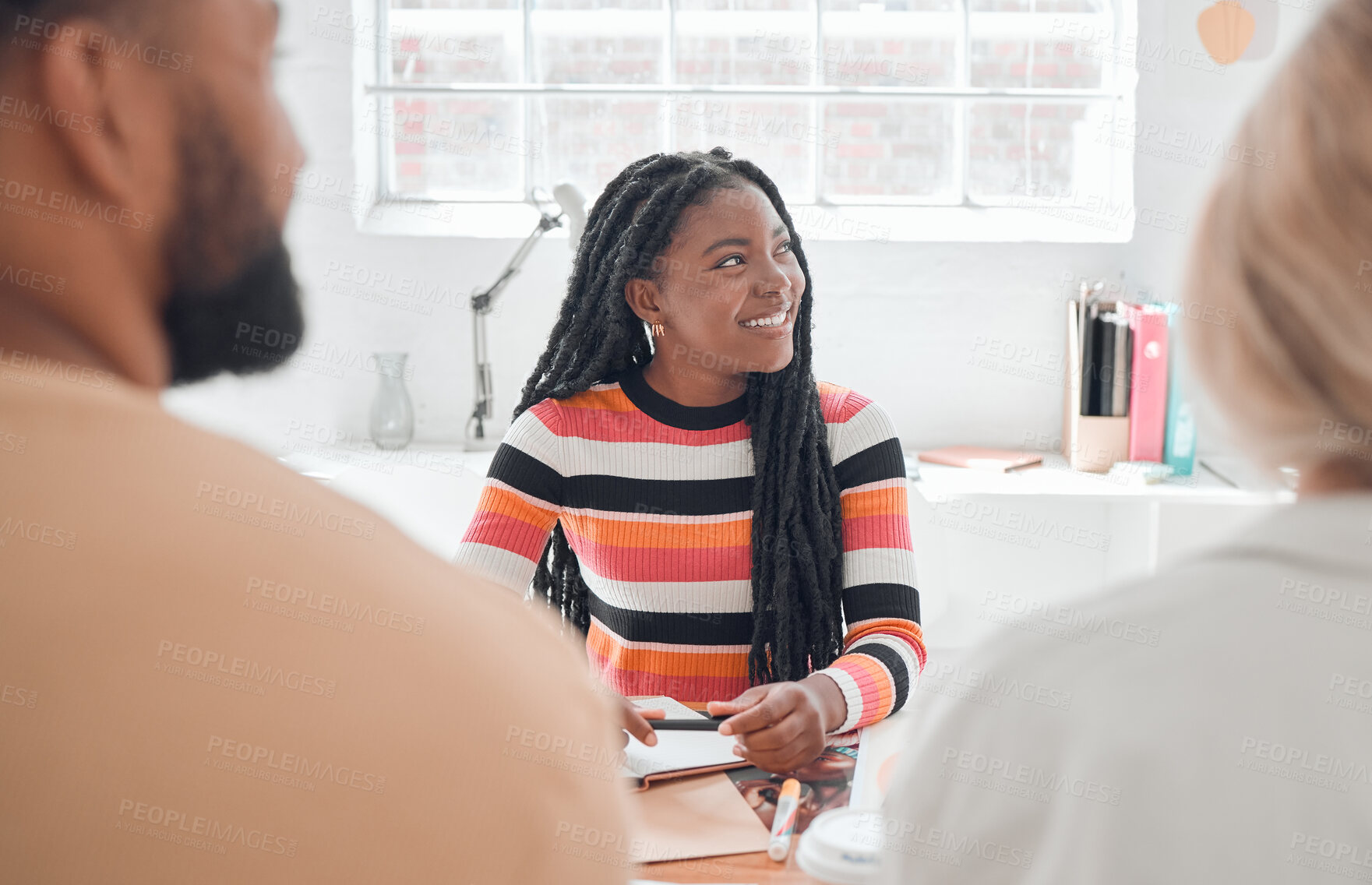 Buy stock photo Group of diverse businesspeople having a meeting in a modern office at work. Young happy african american businesswoman sitting in a boardroom with colleagues. Creative businesspeople planning together