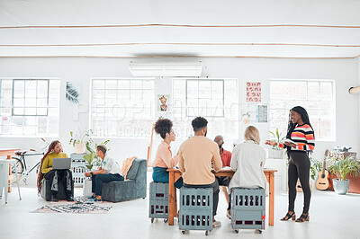 Buy stock photo Group of diverse businesspeople having a meeting in a modern office at work. Young happy african american businesswoman doing a presentation of an idea using a digital tablet in a boardroom with colleagues. Businesspeople planning together