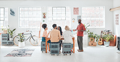 Buy stock photo Group of diverse businesspeople having a meeting in a modern office at work. Young happy african american businessman doing a presentation of an idea using a digital tablet in a boardroom with colleagues. Businesspeople planning together