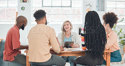 Buy stock photo Group of diverse businesspeople having a meeting in a modern office at work. Young happy caucasian businesswoman smiling while working on a digital tablet in a boardroom with colleagues. Creative businesspeople planning together