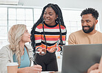 Group of diverse businesspeople having a meeting in a modern office at work. Young african american businesswoman talking to her colleagues while using a laptop. Businesspeople planning together