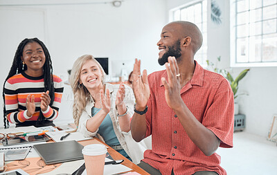 Buy stock photo Group of cheerful diverse businesspeople having a meeting in a modern office at work. Joyful colleagues clapping hands for a coworker while sitting at a table. Creative businesspeople planning together