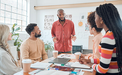 Buy stock photo Group of diverse businesspeople having a meeting in a modern office at work. Young african american businessman doing a presentation of an idea in a boardroom with coworkers. Businesspeople planning together