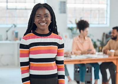 Buy stock photo Young cheerful african american businesswoman standing in an office. Confident black female manager smiling and standing at work