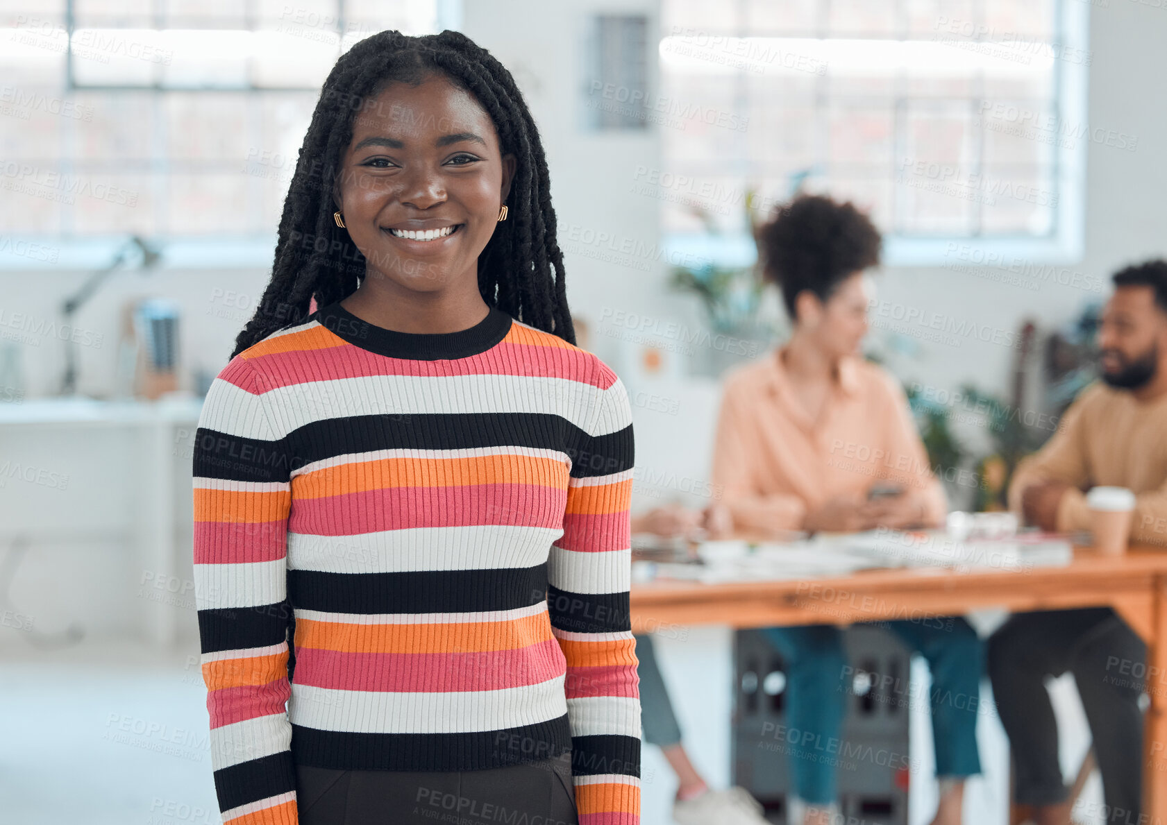 Buy stock photo Young cheerful african american businesswoman standing in an office. Confident black female manager smiling and standing at work