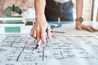 Buy stock photo Closeup shot hand of a woman architect holding a pen and looking over plans, blueprints are schematics. One caucasian business woman brainstorming and planning for her upcoming development project