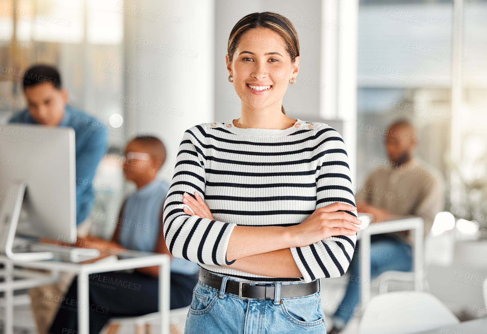 Buy stock photo Young happy mixed race businesswoman standing with her arms crossed while in an office. Confident and content hispanic female boss smiling and standing at work