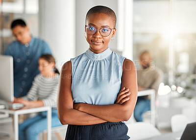 Buy stock photo Young happy african american businesswoman standing with her arms crossed while in an office. Confident and content black female boss smiling and standing at work