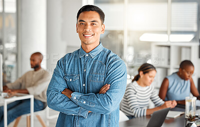 Buy stock photo Young happy mixed race businessman standing with his arms crossed while in an office. Confident and content hispanic male boss smiling and standing at work