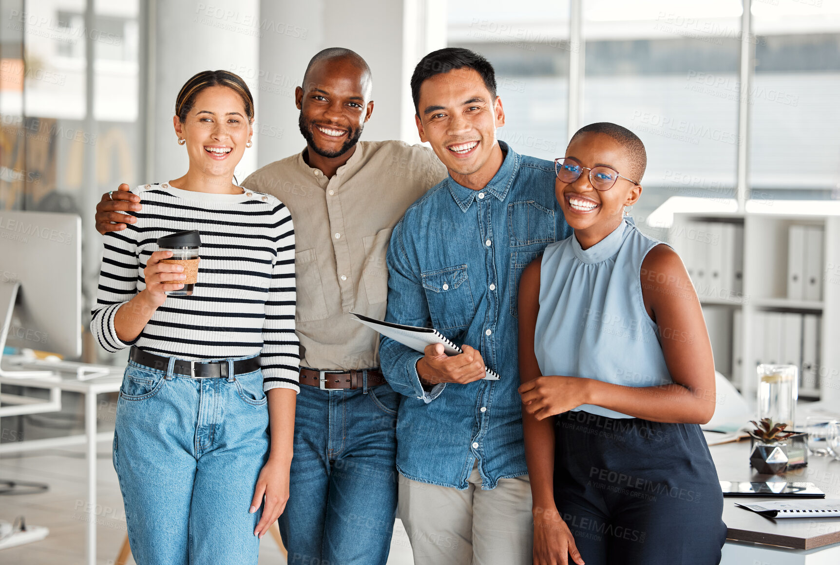 Buy stock photo Portrait of a group of diverse cheerful businesspeople spending time in an office together at work. Happy business professionals smiling while bonding at work