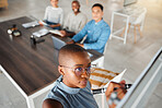 Group of diverse businesspeople having a meeting in an office at work. Young african american businesswoman writing an idea on a whiteboard in a boardroom with colleagues. Businesspeople planning together