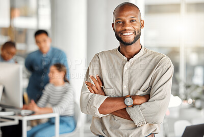 Buy stock photo Young happy african american businessman standing with his arms crossed while in an office. Confident and content male boss smiling and standing at work