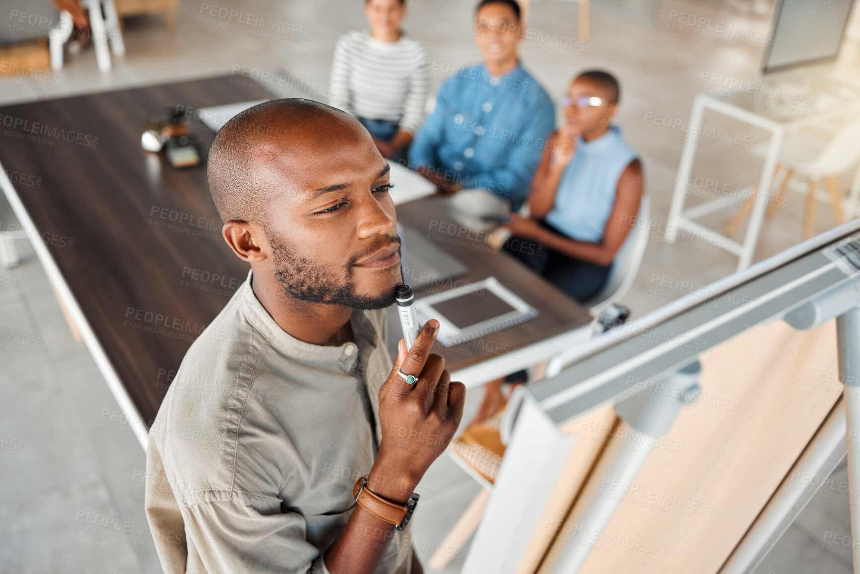 Buy stock photo Group of diverse businesspeople having a meeting in an office at work. Young focused african american businessman thinking of an idea on a whiteboard in a boardroom with colleagues. Businesspeople planning together