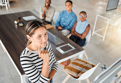 Group of diverse businesspeople having a meeting in an office at work. Young serious mixed race businesswoman thinking of an idea on a whiteboard in a boardroom with colleagues. Businesspeople planning together