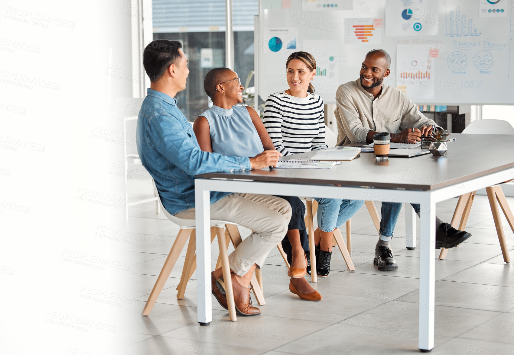 Buy stock photo Group of happy diverse businesspeople having a meeting in an office at work. Cheerful business professionals sitting at a table and talking in an office. Businesspeople planning together