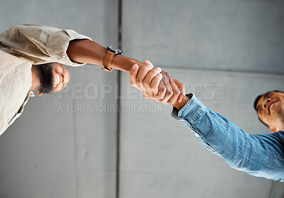 Buy stock photo Two businessmen shaking hands at work. Business professionals greeting and making deals with each other. Boss welcoming a new employee to the workplace. Colleagues collaborating and networking