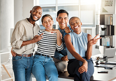 Buy stock photo Portrait of a group of diverse cheerful businesspeople making hand gestures and spending time in an office together at work. Joyful business professionals smiling while bonding at work