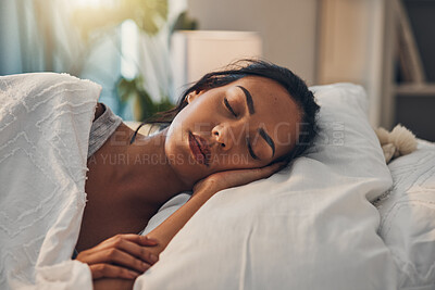 Buy stock photo A beautiful young mixed race woman sleeping in a soft comfortable bed at home. One hispanic female feeling exhausted and resting in a comforting bed