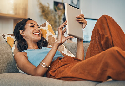 Buy stock photo Woman relax on sofa with tablet, online streaming with internet and reading ebook or watching film at home. Happy female person with technology, subscription and mobile app with break in living room