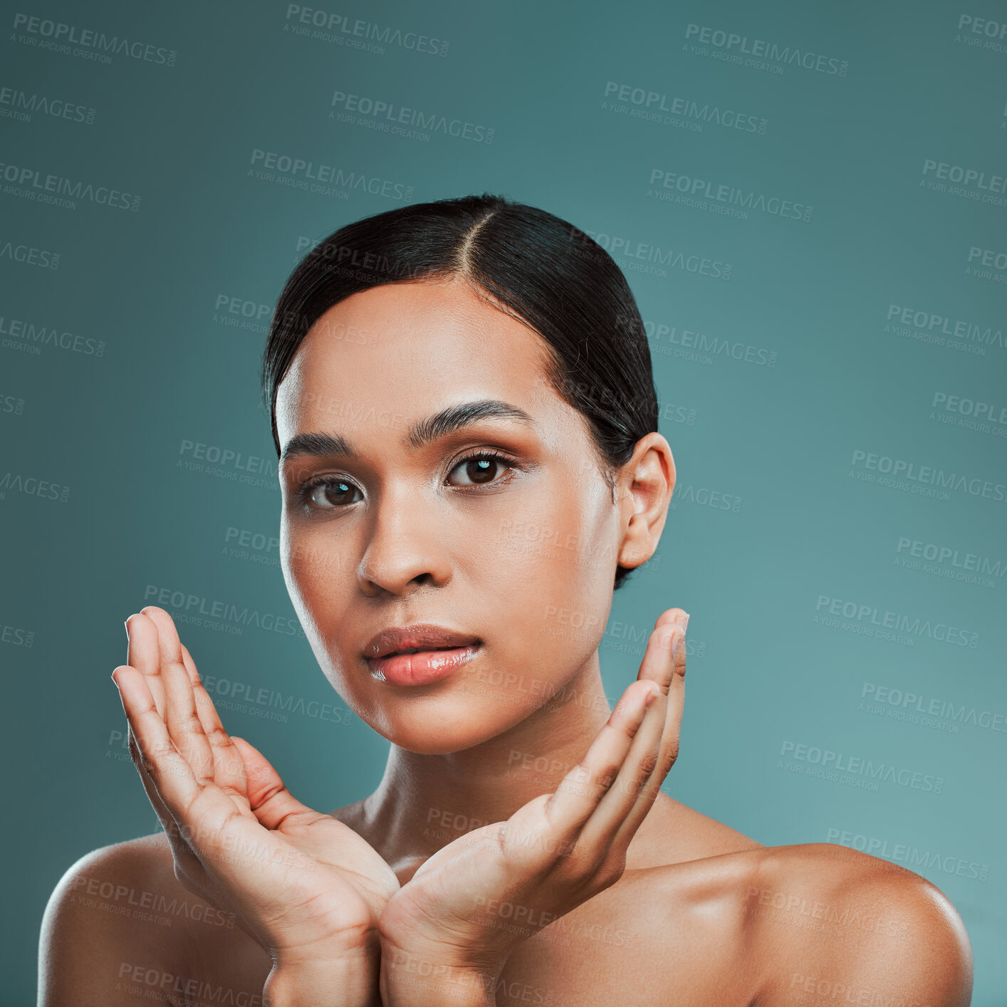 Buy stock photo Portrait of a young beautiful mixed race woman with smooth soft skin posing against a green studio background. Attractive Hispanic female with stylish makeup posing in studio