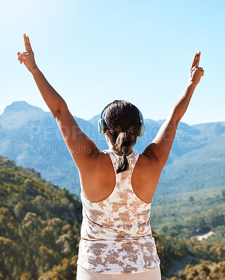 Buy stock photo Rear view of a mature woman standing with her hands raised to the sky feeling free and overlooking a beautiful mountain view