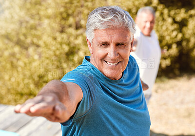 Buy stock photo Happy energetic senior man standing in warrior pose while practicing yoga during fitness class in nature on a sunny day. Seniors living a healthy lifestyle and staying active