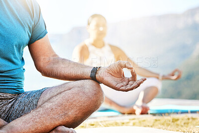 Buy stock photo Close up of a senior man and woman sitting in lotus position and practising meditation during yoga exercise in nature and feeling calm. Retirees living healthy active lifestyle
