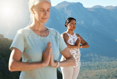 Buy stock photo Senior woman meditating with joined hands and closed eyes breathing deeply. Class of mature people doing yoga together in nature on a sunny day