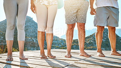 Buy stock photo Close up of a group of seniors feet. Midsection of mature people standing barefoot in a row against a mountain view background. Fitness group standing together in nature