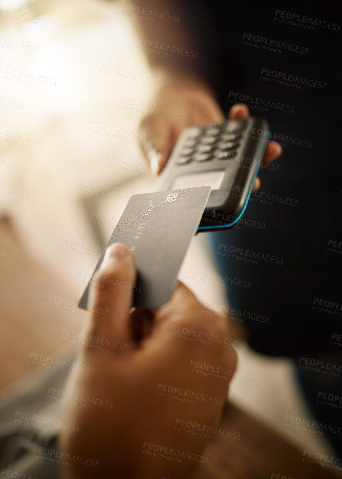 Buy stock photo Designer accepting card payment using an nfc machine. Customer tapping debit card on contactless machine. Closeup on the hands of small business owner using ecommerce card machine for customer
