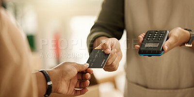 Closeup of hands of a customer paying with a credit card. Entrepreneur accepting payment using a NFC machine. Zoom into hands of a customer making contactless payment using a debit card.