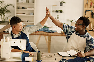 Buy stock photo Two designers giving each other a high five. Tailors celebrate together. Cheerful businesspeople collaborate together in their workshop. Diverse, excited designers celebrating.