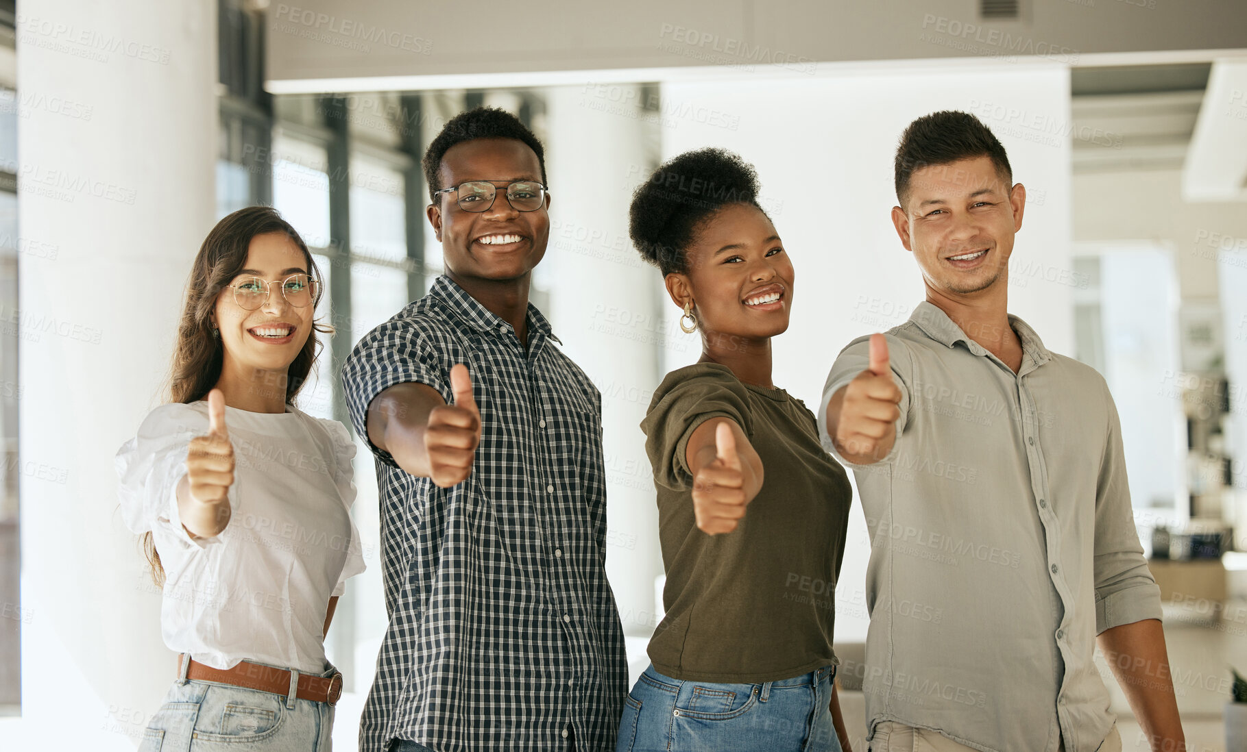 Buy stock photo Group of creative colleagues smiling and gesturing thumbs up in creative office. Diverse business team standing together at startup