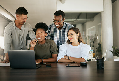 Diverse employees gathered in office having fun watching funny video, discussing new ideas, brainstorming using laptop enjoying break in workday