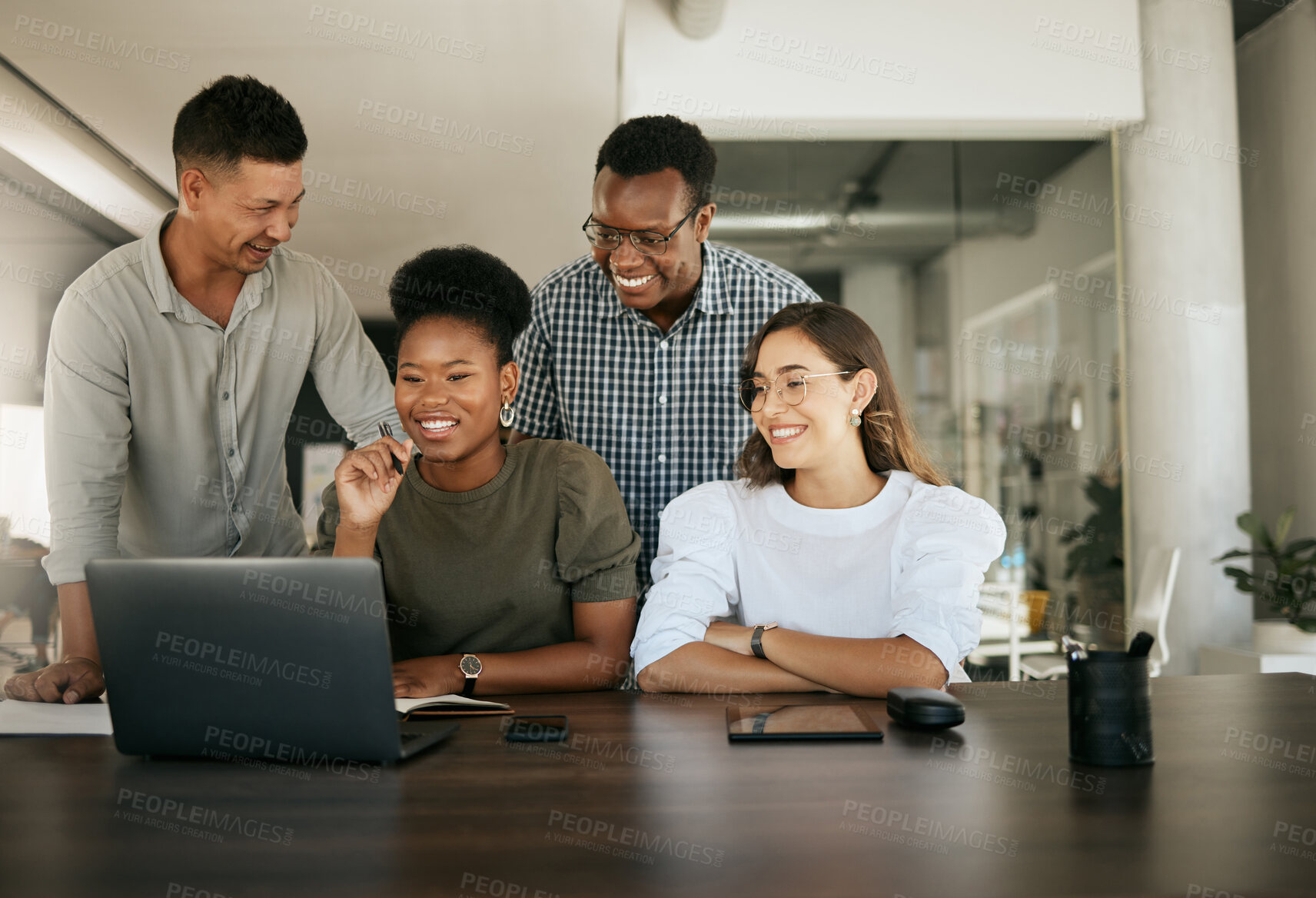 Buy stock photo Diverse employees gathered in office having fun watching funny video, discussing new ideas, brainstorming using laptop enjoying break in workday