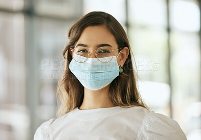 Buy stock photo Business woman wearing protective face mask in the office for safety and protection during COVID-19. Happy mixed race female entrepreneur with glasses and mask at workplace