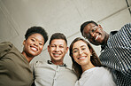 Portrait of happy united young business team hugging each other. Diverse mixed race group of men and women standing in row in their office, huddling and smiling all together