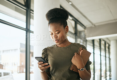 Buy stock photo African american business woman texting on smartphone holding journal and walking in modern office. Smiling female entrepreneur using mobile app or browsing social media
