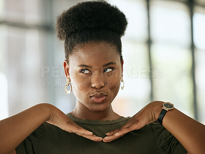 Buy stock photo Happy african american business woman  posing with her hands under her face while pouting and looking away in an office. Playful female entrepreneur making a face