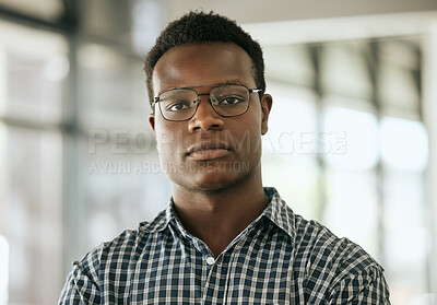 Buy stock photo Portrait of a confident young professional african american business man with glasses standing in an office and looking at camera