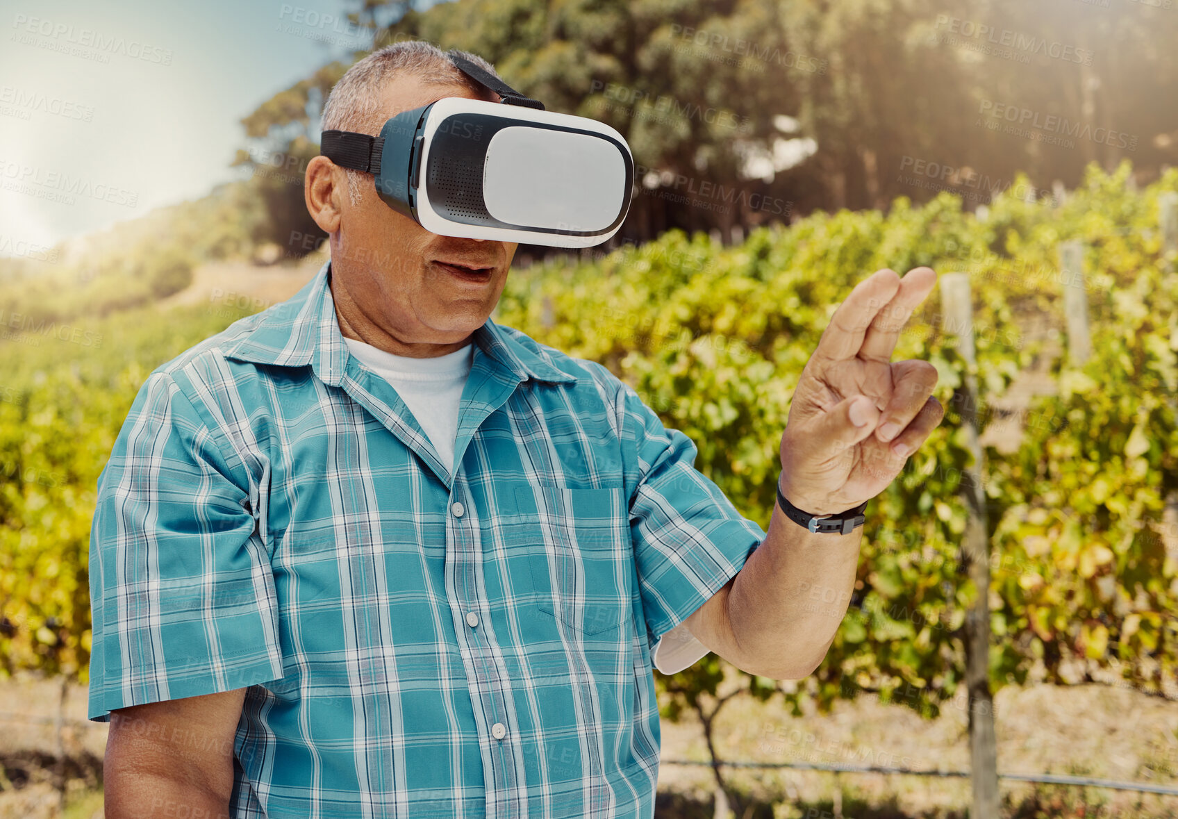 Buy stock photo One senior mixed race farmer using a virtual reality headset through metaverse. Hispanic elderly man touching augmented reality in multiverse. Old man standing alone and using vr for a simulation